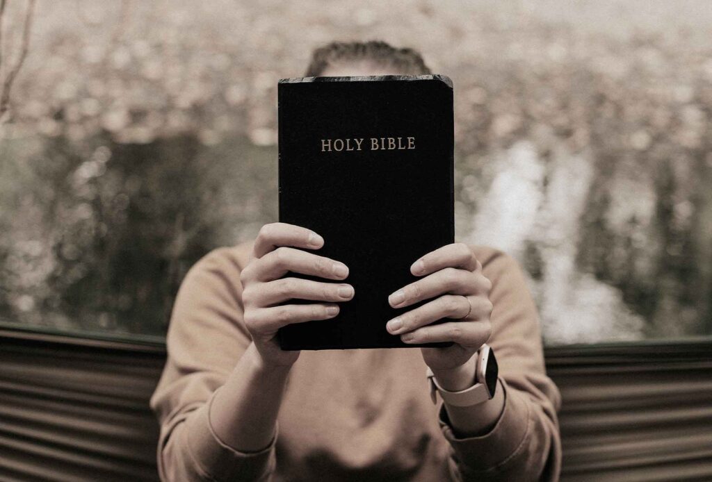 man-holding-a-holy-bible-with-both-hands.jpg