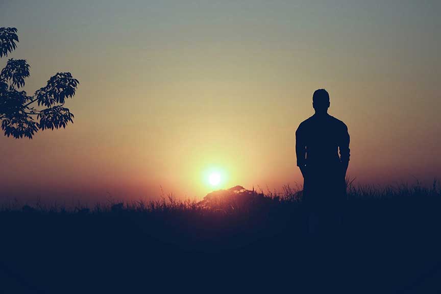Man staring at the sunset BATTLING MENTAL HEALTH STRUGGLES THROUGH LOVE, FAITH, AND UNWAVERING SUPPORT