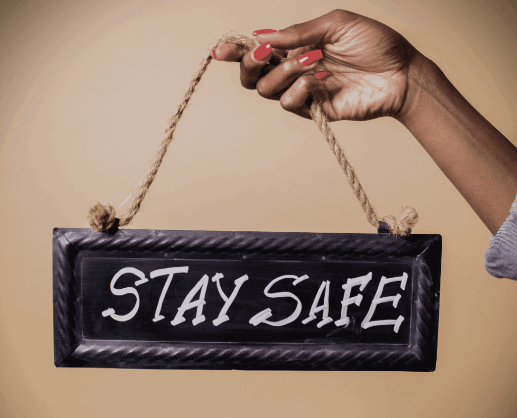 an image of a woman's hand holding a sign that says safe space