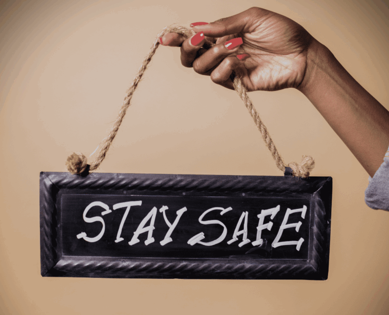 an image of a woman's hand holding a sign that says safe space