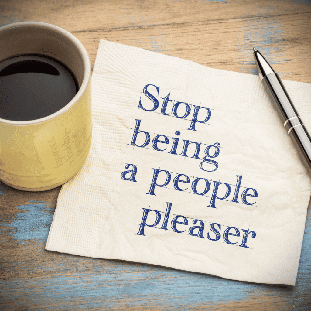 A cup of coffee beside a tissue paper with the handwritten message “stop being a people pleaser,” representing people pleasing as an insidious habit.