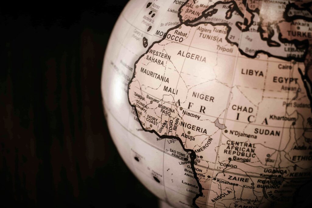 Close up of a globe highlighting countries in West and North Africa, including Nigeria, Ghana, and Morocco.