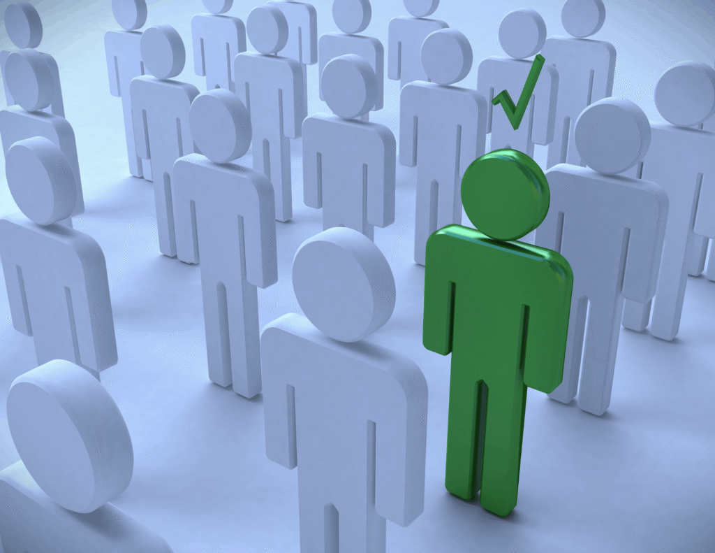 A single green 3D human figure with a checkmark above its head, standing out among a crowd of identical white figures