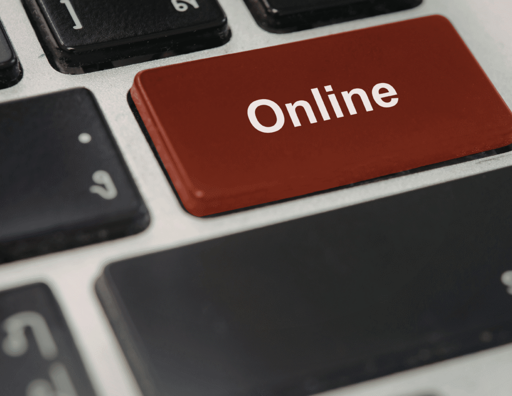 Close-up of a laptop keyboard with a large red-brown key labeled "Online" in white text, replacing a standard key