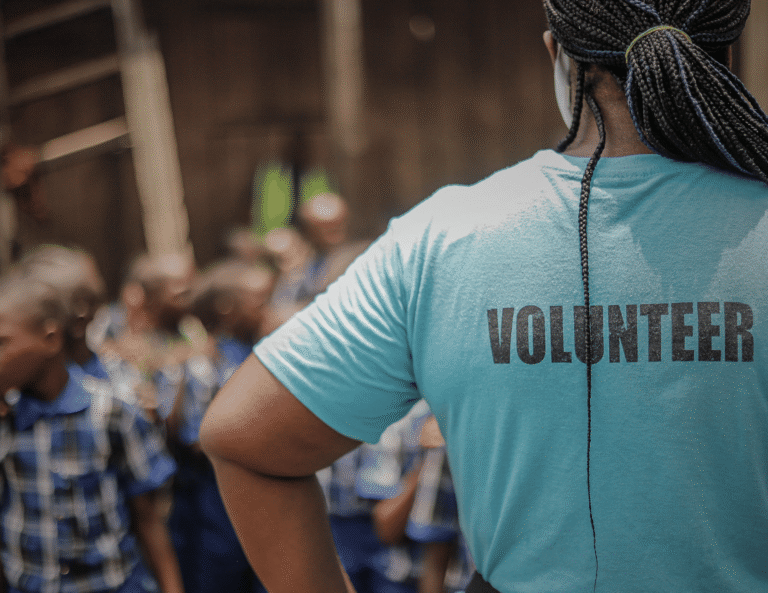 A volunteer working with schoolchildren as part of the community outreach work done by mental health NGOs in Africa